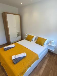 a bedroom with a large bed with two towels on it at Apartmani Marko in Trogir