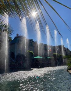 a water fountain in front of a castle at Wyndham Garden Donaueschingen in Donaueschingen