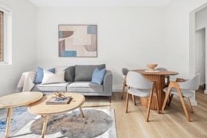 a living room with a couch and a table at Urban Rest Neutral Bay Apartments in Sydney