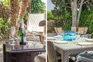 a table with glasses and a bottle of wine at Paola: Preciosa casa pareada con piscina in Sitges