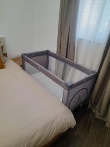 a bed with a metal frame next to a window at Sandstone A8 Marsascala - 15minute drive to Valletta in Marsaskala