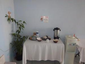 a white table with bowls of food on it at Tropical Court Hotel in Montego Bay