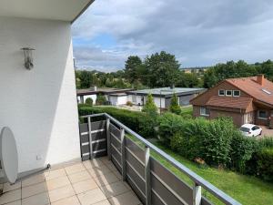 a balcony with a view of a house at Ferienappartment Möhnesee in Möhnesee