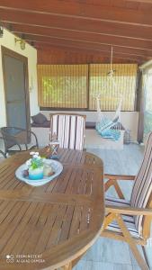 a wooden table with two chairs and a plate on it at Casa Consta Olympus in Litochoro