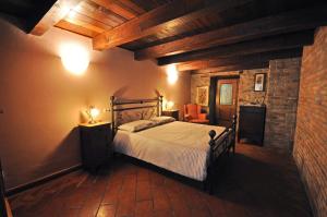 a bedroom with a bed in a room with wooden ceilings at La Corte del Monte 