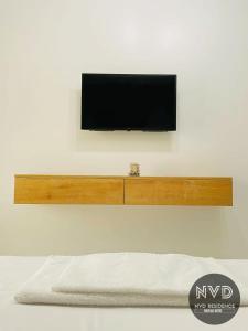 a flat screen tv on a wall with a shelf at NVD Residence Mamaia-NORD in Mamaia Sat/Năvodari +33 photos