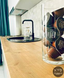 a glass jar on a counter in a kitchen at NVD Residence Mamaia-NORD in Mamaia Sat/Năvodari