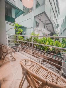 a balcony with benches and plants in a building at Ministry Homestay in Yogyakarta