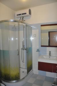 a bathroom with a shower and a sink at Rose Hotel in Hai Phong