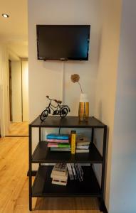 a black book shelf with a bike on top of it at Gemütliche 2-Zimmer Souterrain Wohnung in Düsseldorf