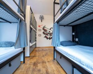 a bedroom with two bunk beds and a wooden floor at The MadHouse Prague in Prague
