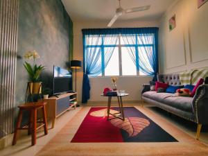 a living room with a couch and a tv at Desig Classic Falim by irainbow in Ipoh