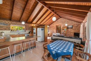 a kitchen and living room with a table and chairs at Coucals Cottage in Mount Crosby