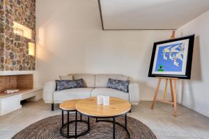 a living room with a couch and a table at Saronis Suites in Saronida