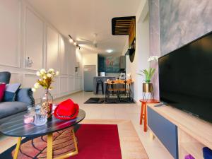 a living room with a large flat screen tv at Desig Classic Falim by irainbow in Ipoh