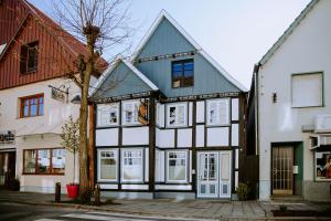 un bâtiment avec des finitions blanches et noires dans une rue dans l'établissement Fritz im Glück, à Rietberg