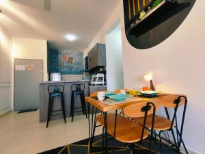 a kitchen with a table and chairs in a room at Desig Classic Falim by irainbow in Ipoh