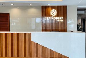 a lobby with a reception desk in a building at Lea Robert Hotel Angeles Pampanga by RedDoorz in Angeles