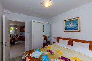 a bedroom with a bed with a colorful blanket at Apartment "Villa M" in Kostrena
