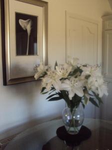 a vase of white flowers sitting on a table at Shannonside Studios in Athlone