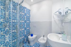 a blue and white bathroom with a toilet and a sink at La fuga blu di Marzamemi in Marzamemi +28 photos