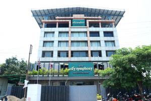 a building with a sign on the front of it at Hotel City Symphony in Nānded