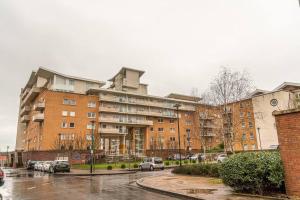 a large building with cars parked in a parking lot at Rueben Suite By Koya Homes - Cardiff in Cardiff