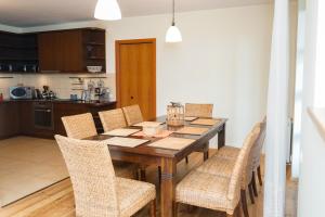 eine Küche und ein Esszimmer mit einem Holztisch und Stühlen in der Unterkunft Domek Prezesa in Kazimierz Dolny