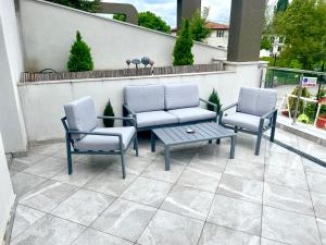 two chairs and a table on a patio at Terrace apartments otopeni ! in Otopeni