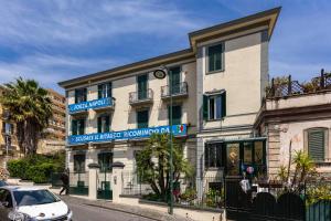 a white car parked in front of a building at La Casa Del Sole A Mergellina in Naples