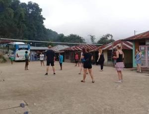 a group of people playing a game of volleyball at WATURAKA TOURISM VILLAGE in Ende