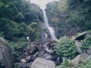 a person standing in front of a waterfall at WATURAKA TOURISM VILLAGE in Ende