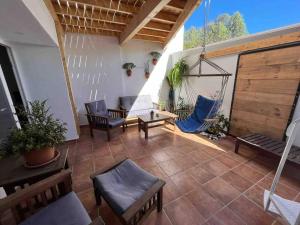 a patio with a hammock and a swing at La Tejita Holiday House in La Tejita