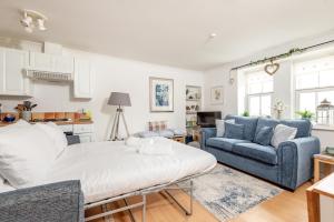 a living room with a couch and a table at Stoney Creek Cottage - Cosy Cottage in the heart of Crail in Crail