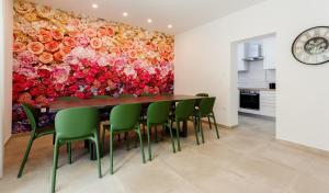 a dining room with a large painting of roses at HOUSE GAZO in Trogir