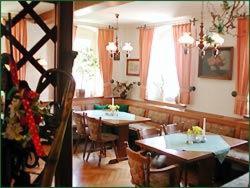 a dining room with tables and chairs and windows at Landgasthof Neitsch in Schwarzenberg
