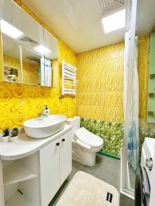 a bathroom with a sink and a toilet and a shower at 135m2 new apartment 5 rooms with airport pickup in Ulaanbaatar