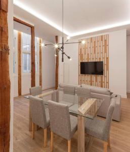 a living room with a table and chairs and a couch at Luxury flat Centro I in Madrid