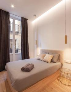 a bedroom with a large bed with two towels on it at Luxury flat Centro I in Madrid
