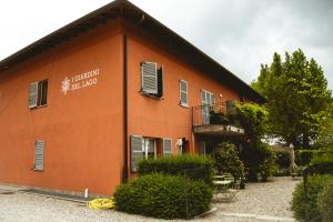 a building with a sign on the side of it at Agriturismo Familiare I Giardini del Lago in Varese