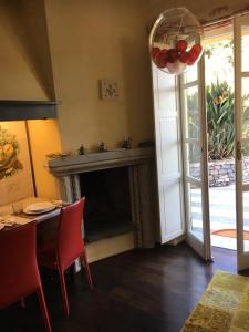 a living room with a fireplace and a table and chairs at Casa Rossa in Portovenere +36 photos