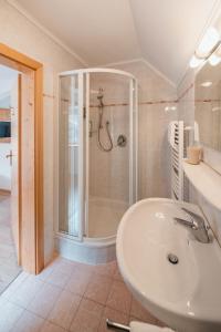 a bathroom with a shower and a sink at Golfhotel Sonne in Siusi