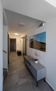 a living room with a table in a room at VULCANO Guesthouse in Vinica