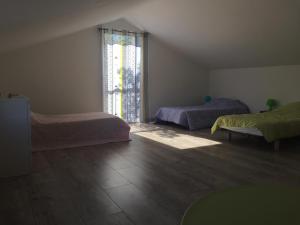 a room with two beds and a large window at Maison Famille 8 pers, Jardin et Terrasse à Jard-sur-Mer - FR-1-336-104 in Jard-sur-Mer