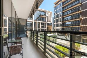 a balcony with a table and chairs and buildings at WelHome - Luxury Living in Dubai's City Walk Building 5 in Dubai