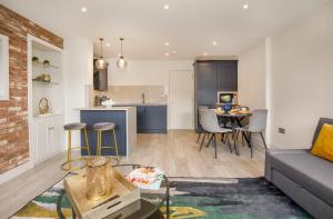 a living room with a couch and a kitchen at York Luxury Apartments, Bishopthorpe Rd in York