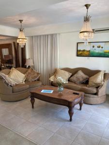 a living room with two couches and a coffee table at Anna Villa in Protaras