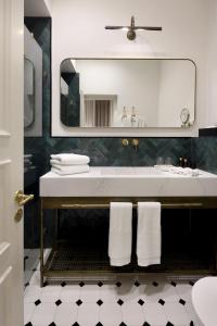 y baño con lavabo blanco y espejo. en Allegro Neve Tzedek Boutique Suites - By HOMY, en Tel Aviv