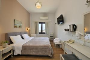 a bedroom with a bed and a sink and a mirror at Dryades & Orion Hotel in Athens