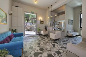 a living room with a blue couch and chairs at Dryades & Orion Hotel in Athens